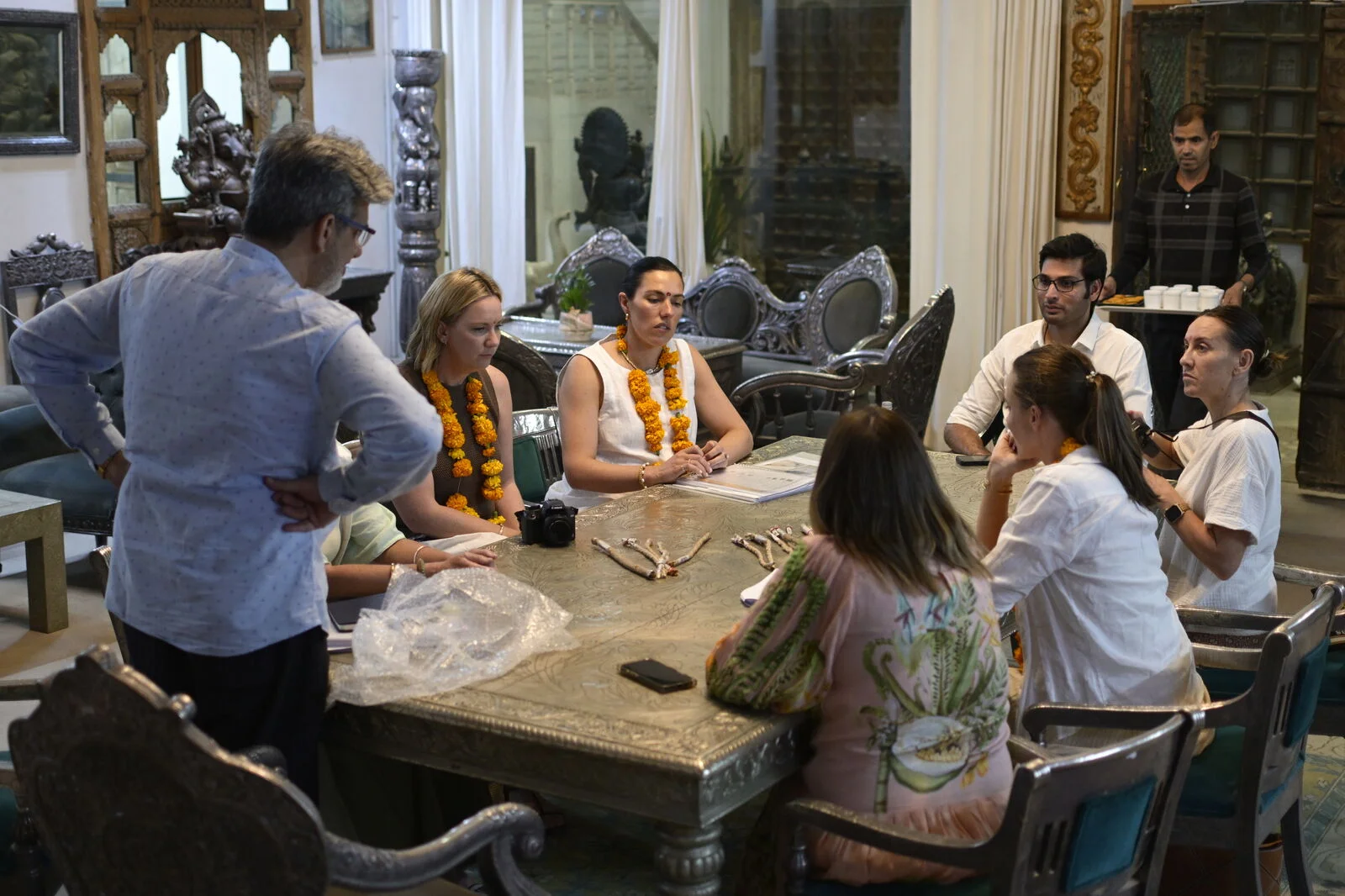 The Source Haus India team and visitors discussing samples around a table