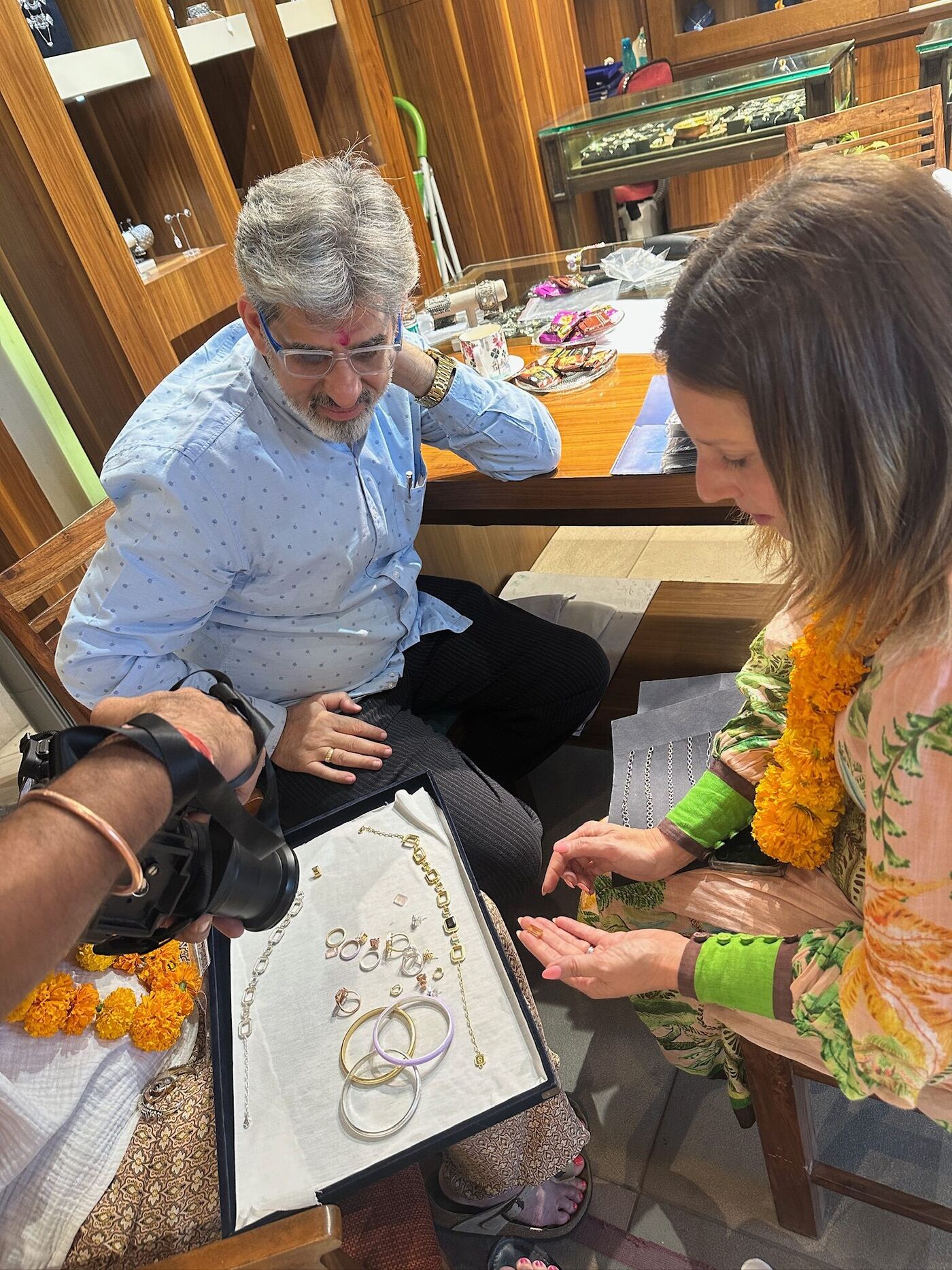 Kristy reviewing jewellery samples at a market counter