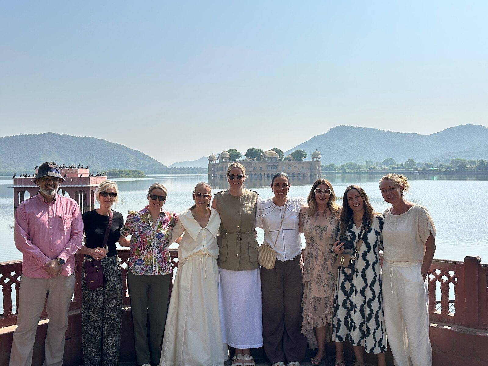 A sourcing trip group together by a lake in India